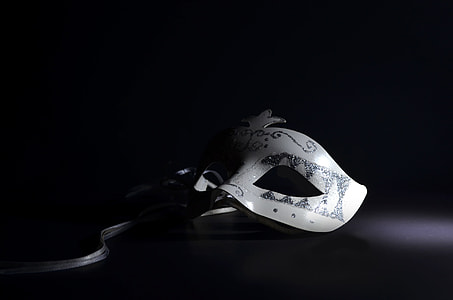 closeup photography of white masquerade eye mask