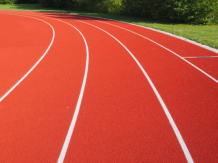 red and white track field during day time