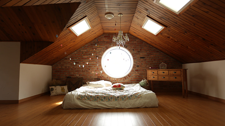 white bed linen inside brown wooden room