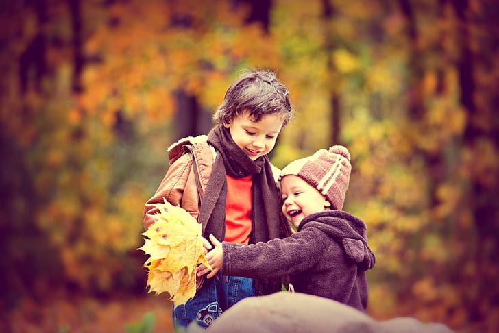 two children holding leaf