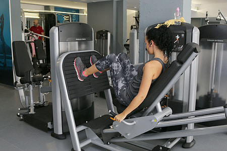 woman using leg press exercise equipment