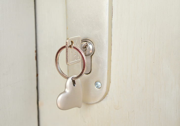 gray metal door lock with stainless steel key