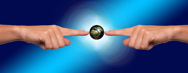 person hand pointing on earth