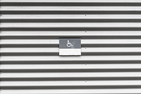 Metal Wall with Wheelchair Disabled Sign