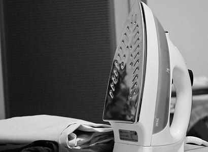 grayscale photography of clothes iron and textile