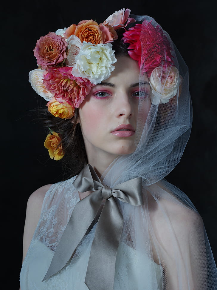 woman wearing floral head dress and white veil