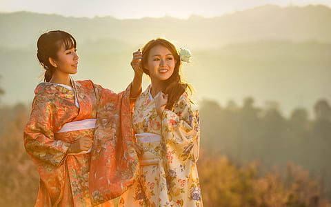 women wearing yellow and orange kimonos