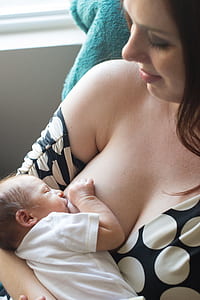 baby feeding on woman's breast