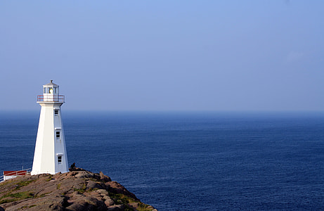 white lighthouse near sea at daytime