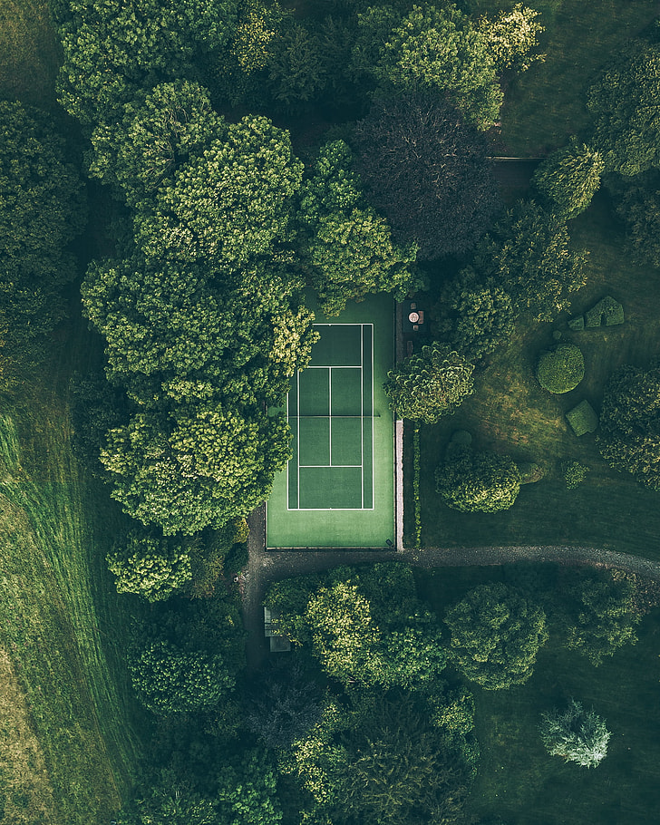 aerial view of tennis court between trees
