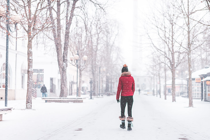 Young Woman Walking Alone in The Park in Snowy Weather