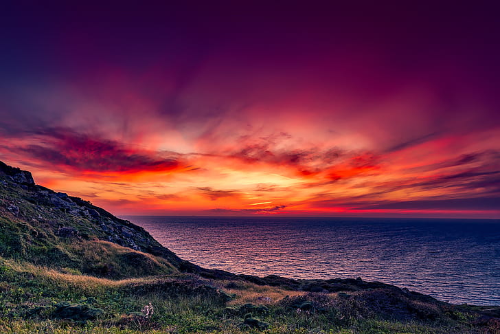 landscape photo of hill, sunset, and ocean