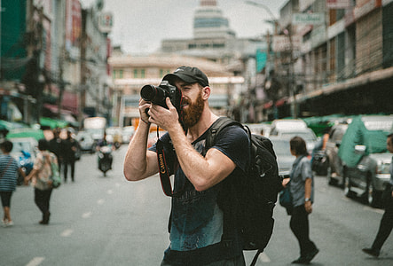 selective focus photo of man wearing black t-shirt about to take picture