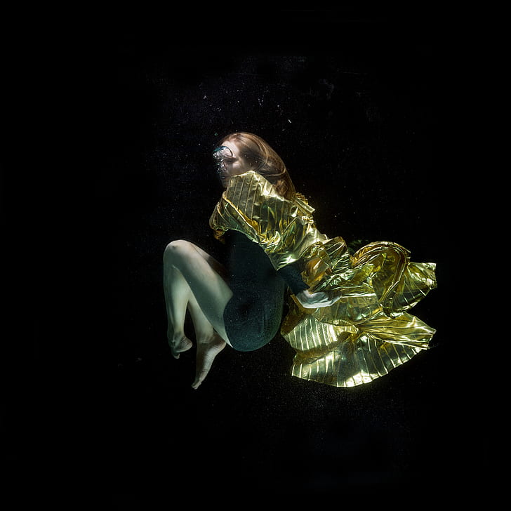 underwater photography of woman in green dress