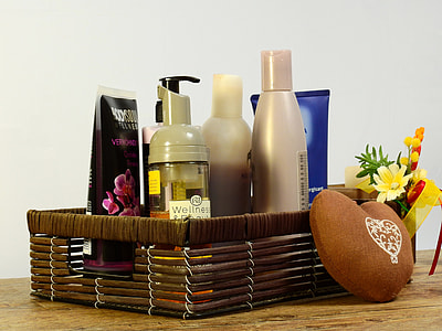 cosmetic products in brown wicker basket