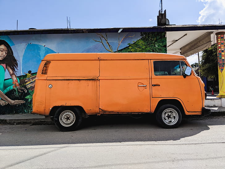 orange van beside concrete house