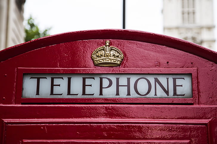 red and white Telephone booth sign