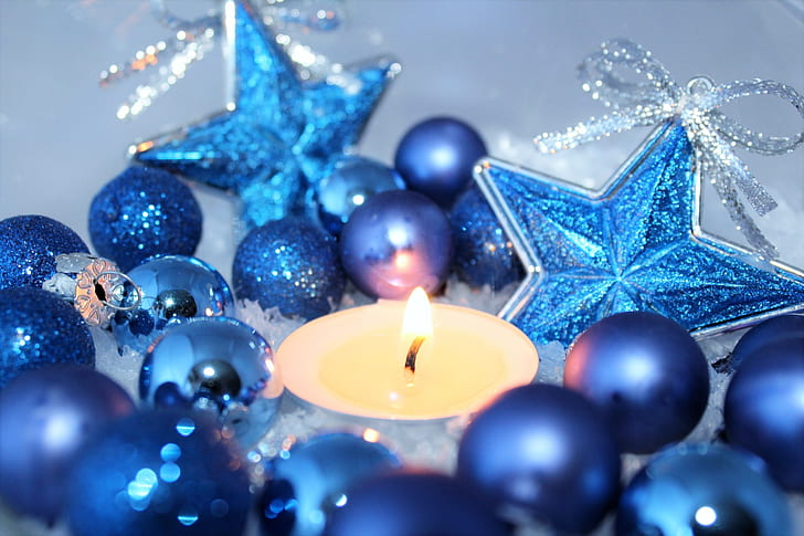 blue Baubles near yellow candle