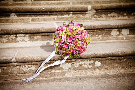 pink and yellow petaled flowers bouquet in the stairs