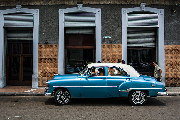 A classic car sits on an old street in Havana, Cuba. Image captured with a Canon DSLR
