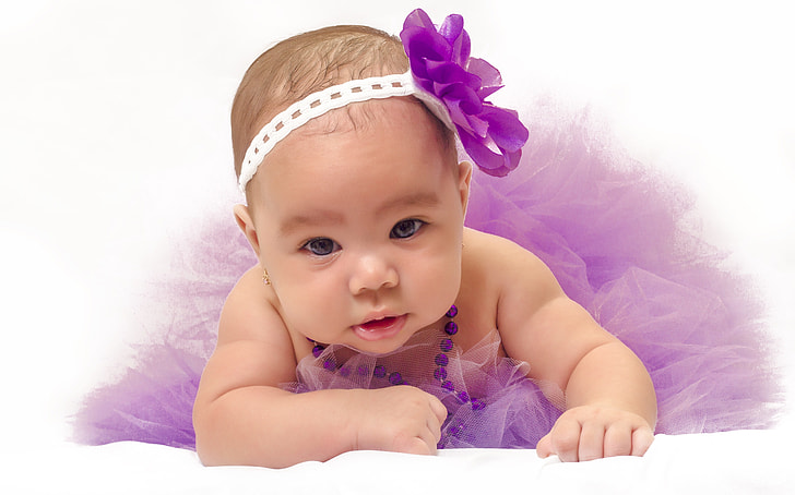 baby wearing purple tutu skirt