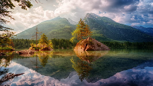 body of water with mountain in the background