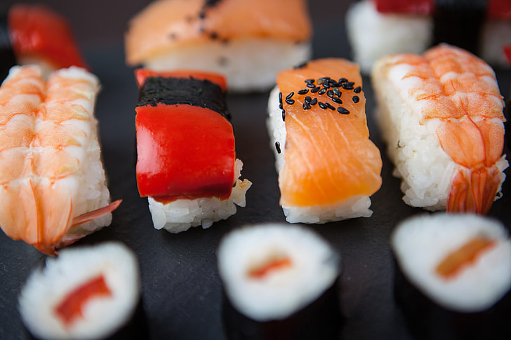 Close-up macro shot of fresh sushi fish resting on a slate