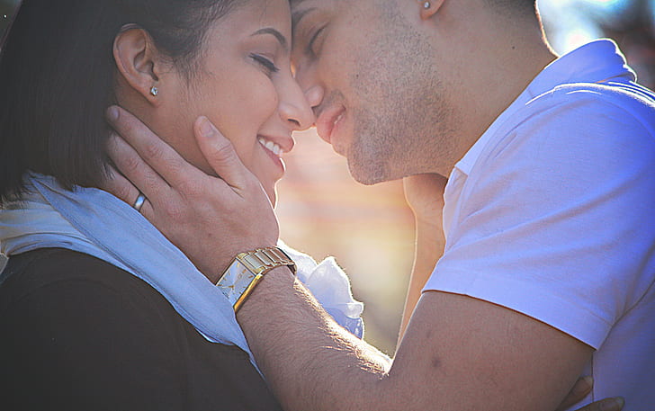 man and woman about to kiss during daytime