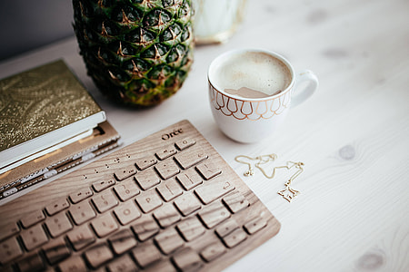 Wooden keyboard and cup of coffee
