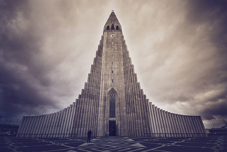 grey cathedral under cloudy sky in sepia mode photo