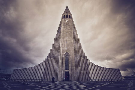 grey cathedral under cloudy sky in sepia mode photo