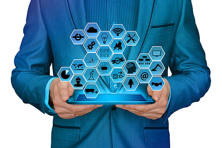 person holding blue tablet with hologram applications