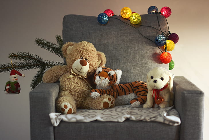 brown bear, tiger, and dog plush toys on black sofa chair