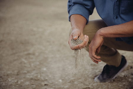 man holding gray sands