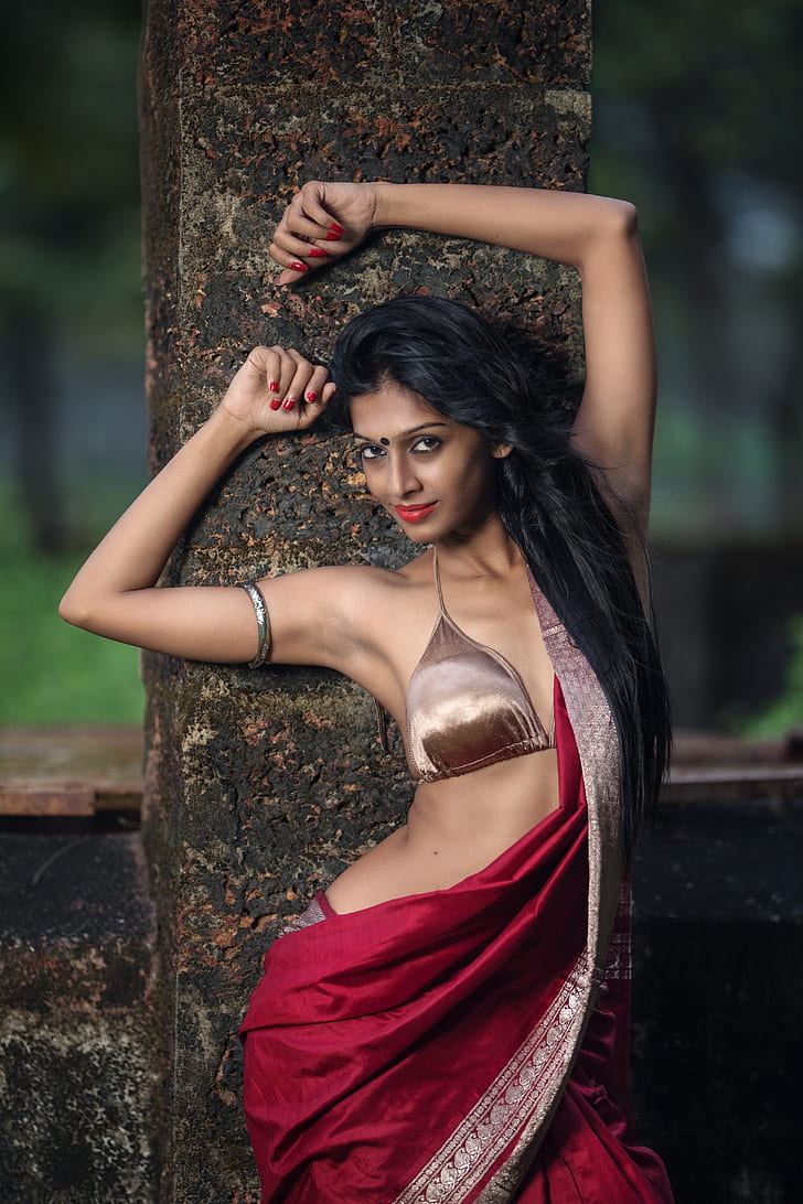 woman in bronze-colored brassiere and red sari dress