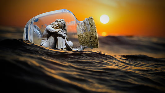 woman sitting inside cork covered bottle floating on water against sunset
