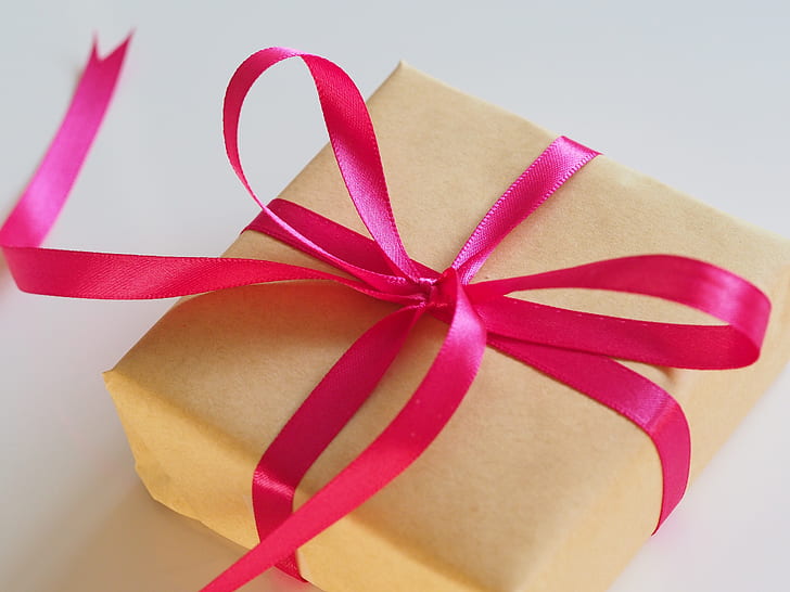 photo of square yellow box with pink ribbon
