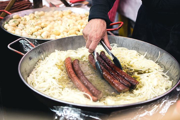 Cooking sausages with onion