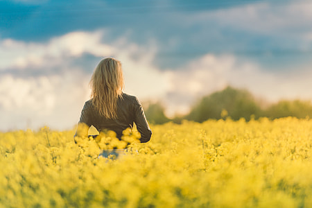 Woman in Yellow Field at Sunset