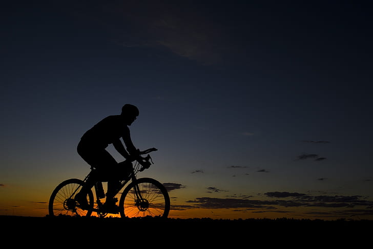 silhouette photo of biker