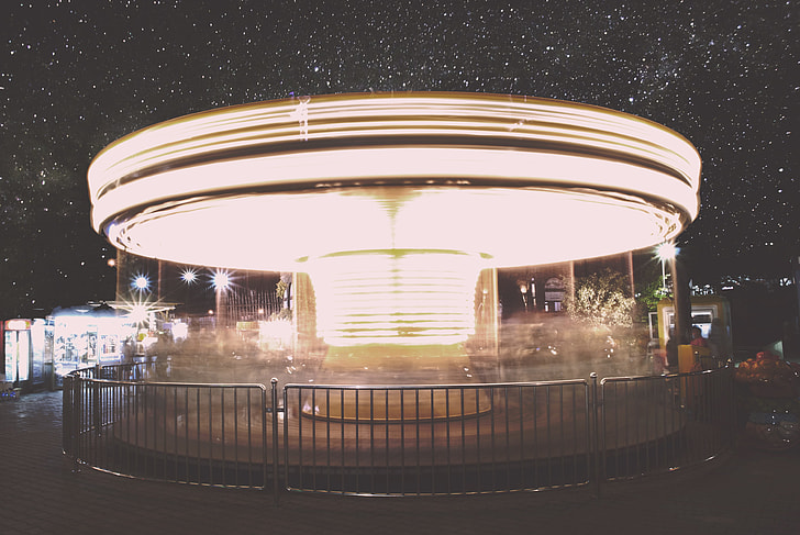 time lapse photography of lighted horse carousel under clear starry sky