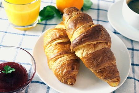 two croissant breads on white saucer
