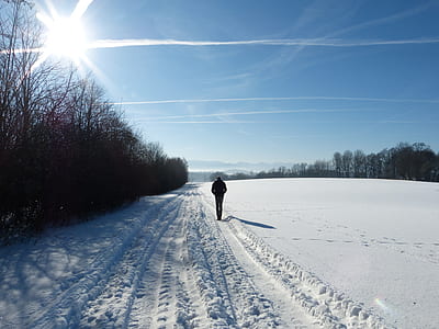 person walking on the snow during daytime