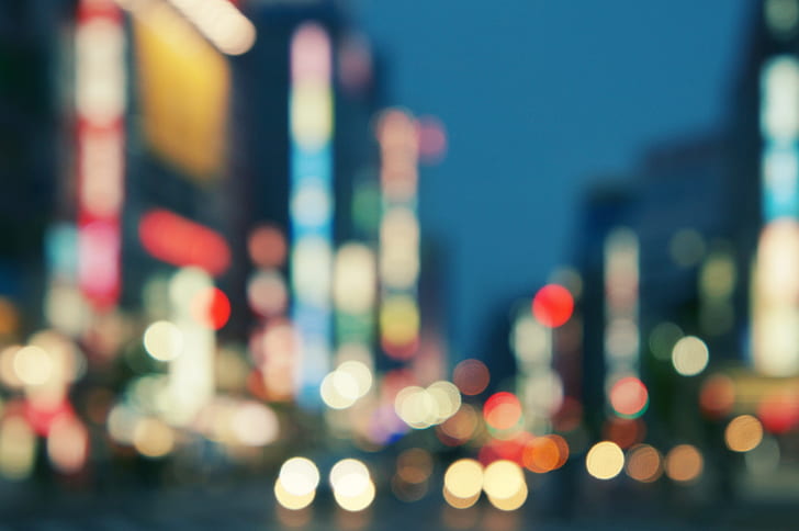 bokeh photography of city buildings and stret