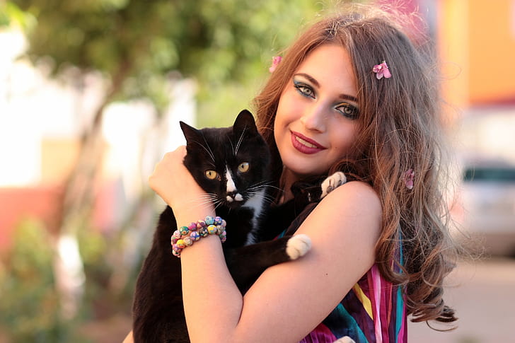 woman holding tuxedo cat