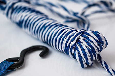selective focus and closeup photography of blue and white stripe rope