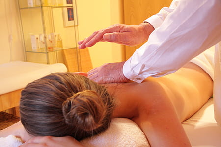 woman in prone position having a back massage