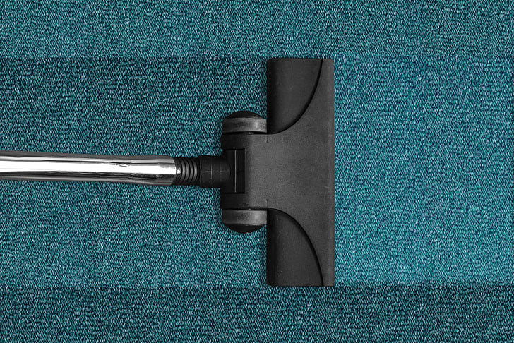 black and gray steam mop on blue mat