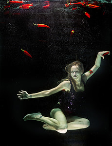 photography of woman floating on body of water