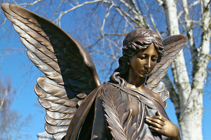 selective focus photography of angel statue